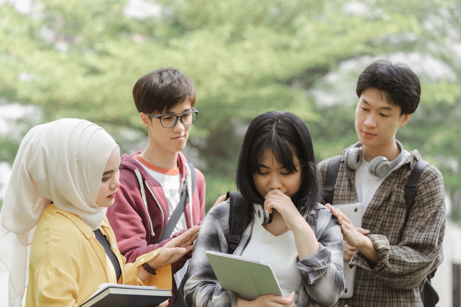 Students supporting a classmate during A-Level prep from economics tuition